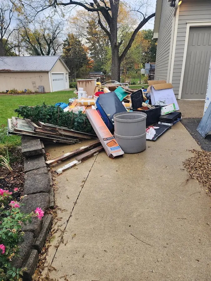 Dumpster being loaded with debris for Estate Cleanout Dumpster Rental in Fort Worth